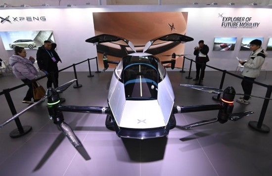 2023年12月1日，在鏈博會(huì)智能汽車鏈展區(qū)小鵬汽車展臺(tái)，參觀者觀看一臺(tái)智能飛行器。新華社記者蔡湘鑫攝