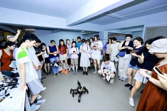 8月25日，中外青年在浙江杭州觀看機器人表演。新華社發(fā)（清華大學(xué)供圖）