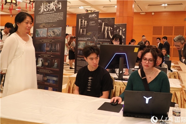 在活動現(xiàn)場，當(dāng)?shù)孛癖婓w驗(yàn)“數(shù)字藏經(jīng)洞”云游戲，沉浸式體驗(yàn)敦煌文化。 人民網(wǎng)記者 李志偉攝