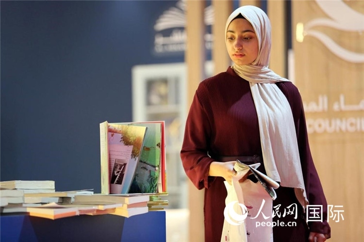 一名女性走過展臺。人民網(wǎng) 奧馬爾·哈利勒攝