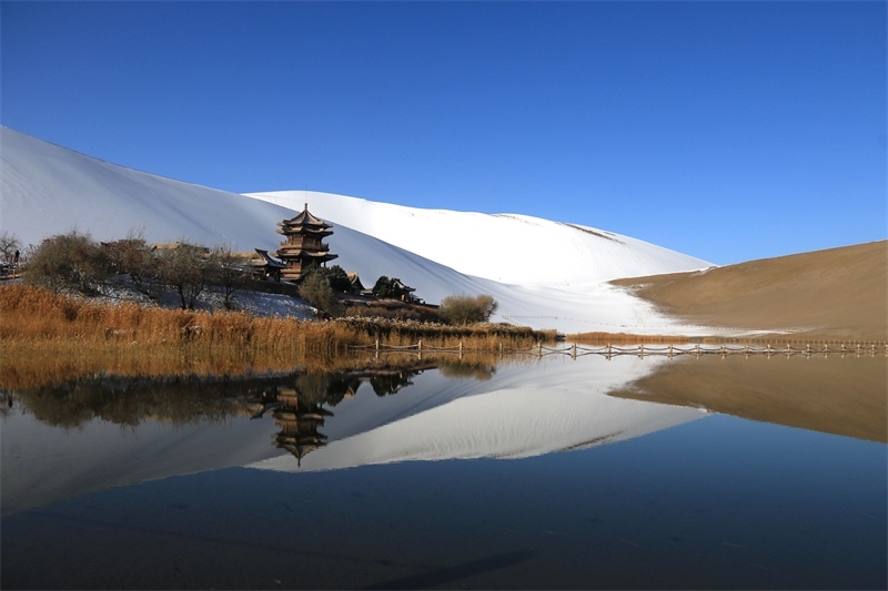 鳴沙山月牙泉景區(qū)雪景。敦煌市委宣傳部供圖，張曉亮攝